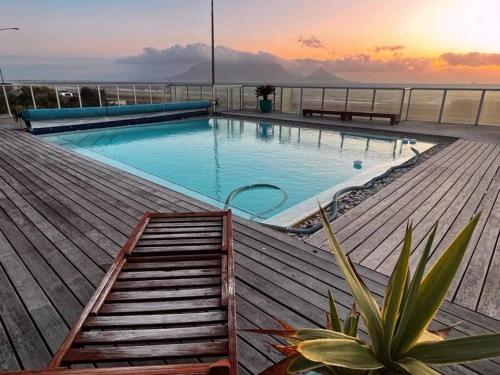 a swimming pool on top of a building at Luxurious 2-bedroom beach apartment with a view! in Bloubergstrand