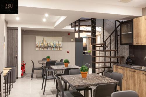 un restaurant avec des tables et des chaises et un escalier dans l'établissement Modern, Large and Spacious HOME, Perfect for GROUP by 360 Estates, à Msida