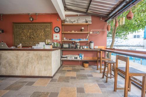 a bar in a restaurant with a swimming pool at Yi's Garden Villa in Chiang Mai