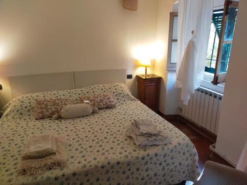 1 dormitorio con 1 cama con 2 toallas en APPARTAMENTO INCANTEVOLE CON GIARDINO, en Génova