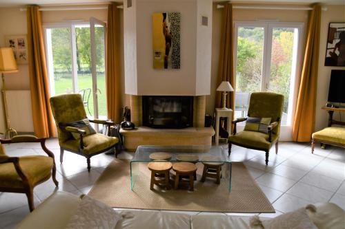 a living room with a couch and a fireplace at Maison Marguerite in Bordères-Louron