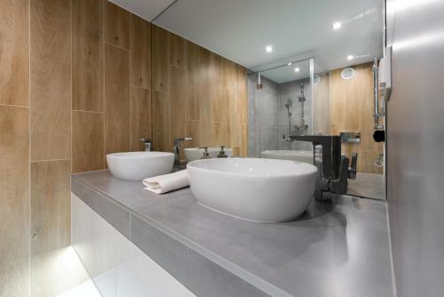a bathroom with a large white tub on a counter at Apartamenty Centrum nowoczesny design - Dream Apart in Bielsko-Biala