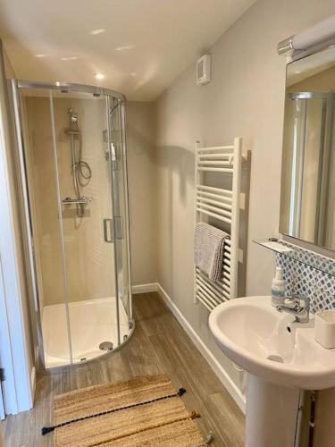 a bathroom with a shower and a sink at Little Innsacre in Bridport