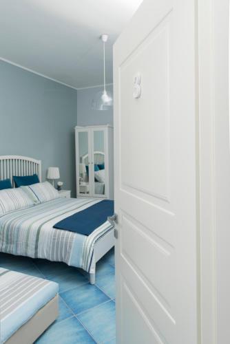 a bedroom with two beds and a white door at CAPRI B&B in Salerno