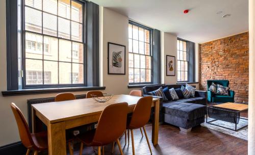 a living room with a table and a couch at The Cavern Quarter Aparthotel by UStay in Liverpool