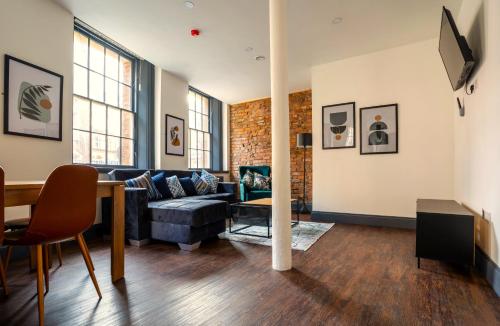 a living room with a couch and a table at The Cavern Quarter Aparthotel by UStay in Liverpool