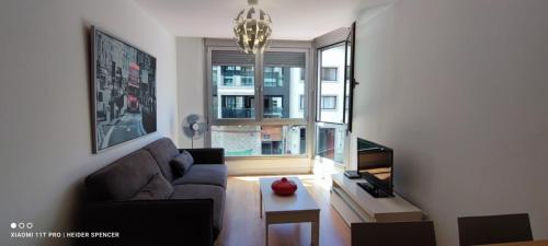 a living room with a couch and a window at Las Canteras OP2 in Las Palmas de Gran Canaria