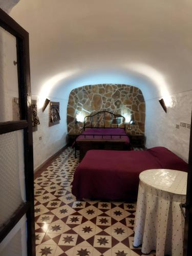 a room with two beds and a table at Cuevas Baza in Baza
