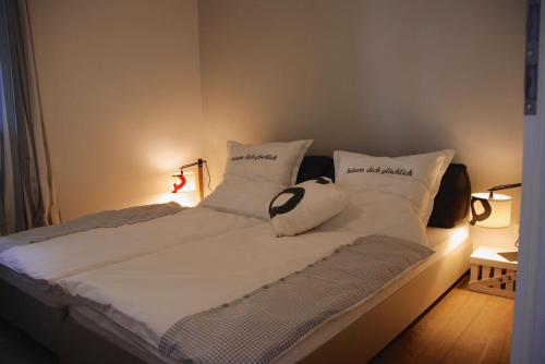 a bed with white sheets and pillows on it at Sealounge in Dassow