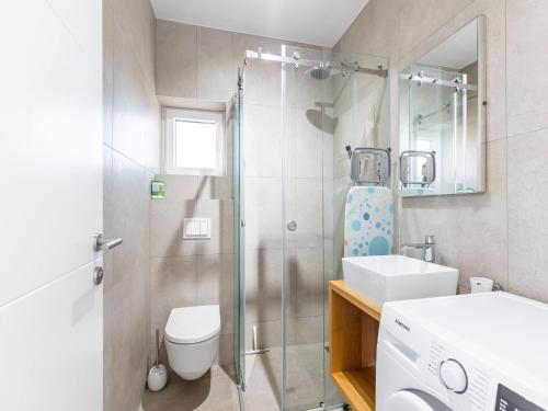 La salle de bains est pourvue d'une douche, de toilettes et d'un lavabo. dans l'établissement Modern holiday home in Bilice with private pool, à Bilice