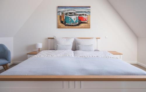 a bedroom with a large bed and a painting on the wall at Cottage am Meer - Maisonette mit Wohlfühlambiente - a72564 in Rerik