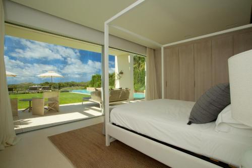 a bedroom with a bed and a view of a patio at Contemporary Ibizan Villa Cala Conta Dream Short Walk to Beach San Jose in Cala Comte