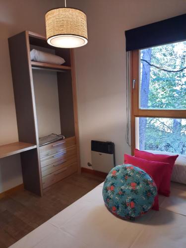 a bedroom with a large window and a circular chair at Orn, Chill Out Houses By A.M.A in San Carlos de Bariloche