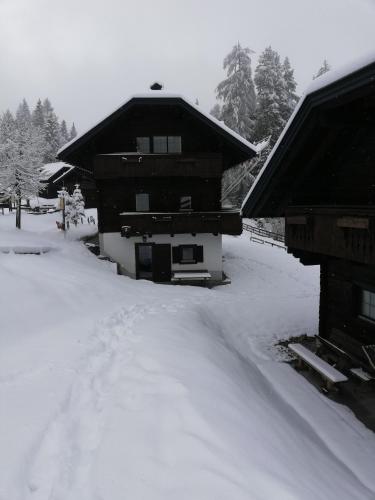 a house covered in snow in front at Hapimag Ferienwohnungen Sonnleitn in Sonnenalpe Nassfeld