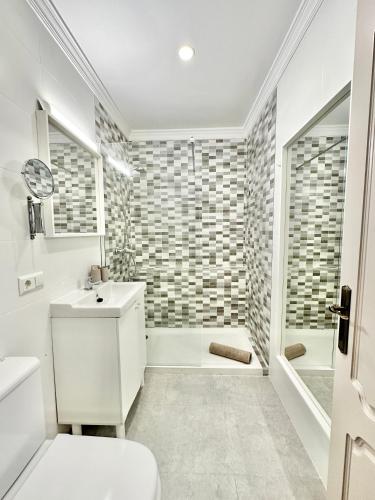 a bathroom with a toilet sink and a shower at Marbella Old Town-300m from the beach in Marbella