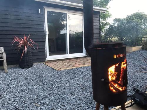 a fire pit in a yard next to a house at The Bay Cabin, secluded retreat Freshwater Bay in Freshwater