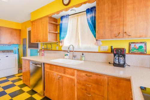 a kitchen with wooden cabinets and a sink at The Nook on Chinook in Tillamook