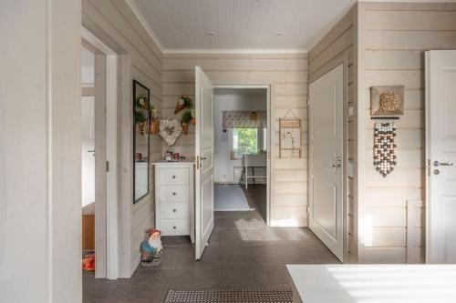 a kitchen with white walls and a hallway at Majestic 3 Bedroom Villa With Sauna in Rovaniemi