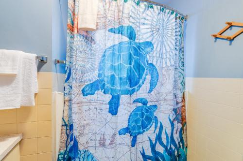 a shower curtain with a turtle on it in a bathroom at The Nook on Chinook in Tillamook