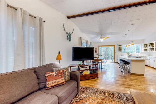 a living room with a couch and a flat screen tv at Riverbend in Joseph