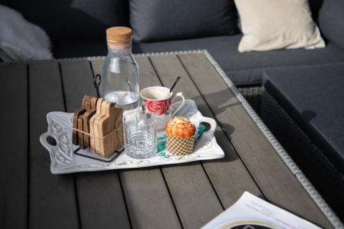 a table with a tray of food and a bottle at Design 2BDR Apartment with Balcony- FREE PARKING in Zagreb
