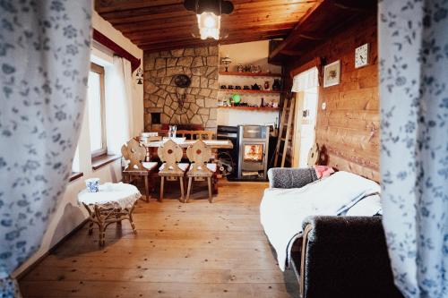 a living room with a couch and a table at chata u Tesáku in Rajnochovice