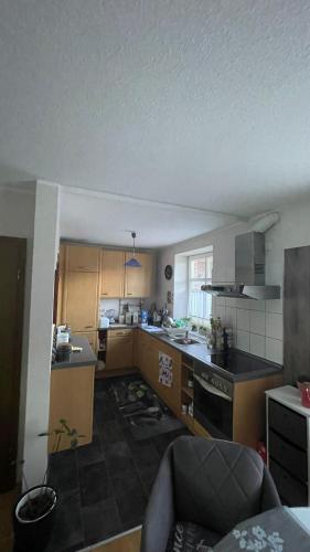 a small kitchen with a stove and a couch at Wohnung am Mittellandkanal in Bohmte