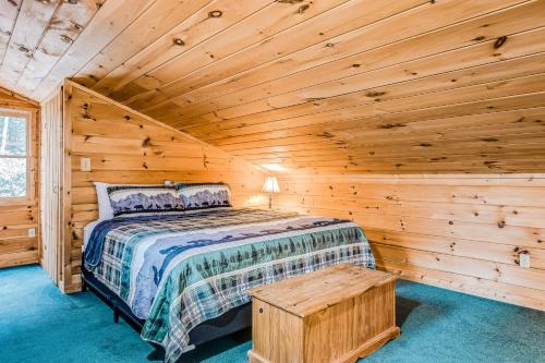 a bedroom with a bed in a log cabin at Emerald Forest in Ellijay