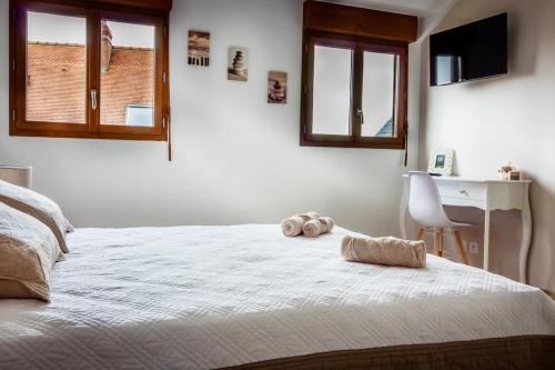a bedroom with a bed with a stuffed animal on it at Le Verger du Mesnil in Le Mesnil-Réaume