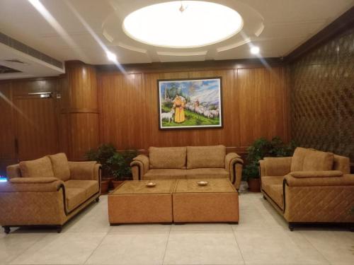 a living room with two couches and a coffee table at Namastasya in Solan