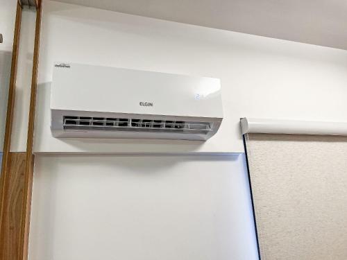 a refrigerator with a air conditioner on top of it at Condomínio Residencial Unique Residence - São José do Rio Preto in Sao Jose do Rio Preto