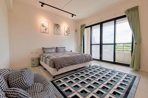 a bedroom with a bed and a large window at 台南水沐安平包棟民宿 in Tainan