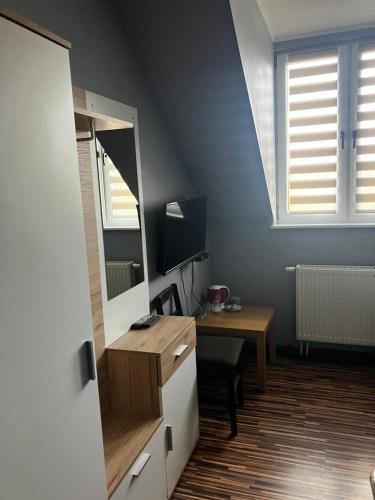 a room with a desk and a mirror and a table at Wisełka in Płock