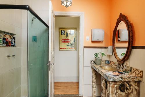 a bathroom with a sink and a mirror at Discovery Hostel in Rio de Janeiro