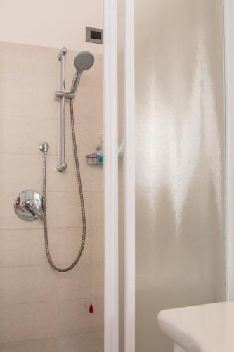 a shower with a shower head in a bathroom at Monolocale Sosta Sul Lago in Lezzeno