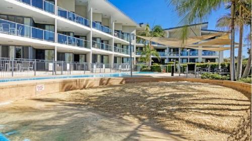 an empty pool in front of a building at Boathouse Premium Apartment 102 in Tea Gardens