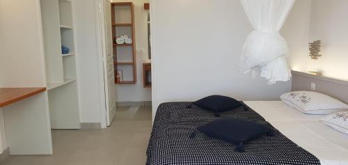 a bedroom with a bed with two pillows on it at Villa Blue Marine in Deshaies