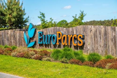a wooden fence with a sign that says europes at Europarcs De Wije Werelt in Otterlo