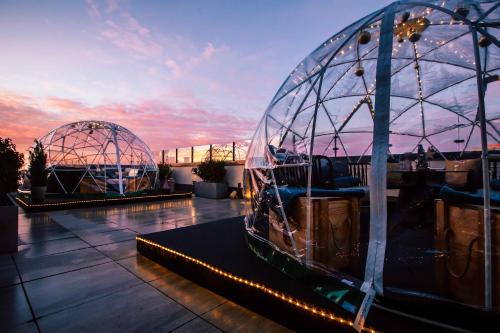 a dome on the roof of a building with a sunset at INNSiDE by Meliá Leipzig in Leipzig