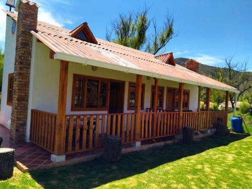 a house with a porch with a roof at Sol y Luna Villa Campestre in Iza