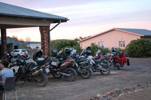 a row of motorcycles parked in a parking lot at Oupoort Eco & Guest Farm - Sutherland - Middelpos in Sutherland