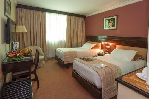 Una cama o camas en una habitación de Hotel Toubkal
