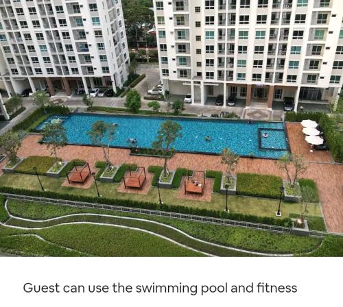 a swimming pool in a city with buildings at Gsuite Glamorous Apartment in Bangkok