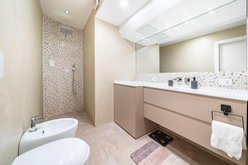 a bathroom with a toilet and a sink and a mirror at Baie Roquebrune, Vue Mer, Parking Gratuit - AJ in Roquebrune-Cap-Martin