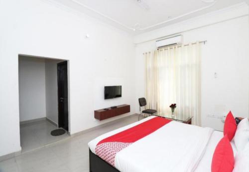 a bedroom with a large bed and a television at IIDM ECO RESORT in Lucknow