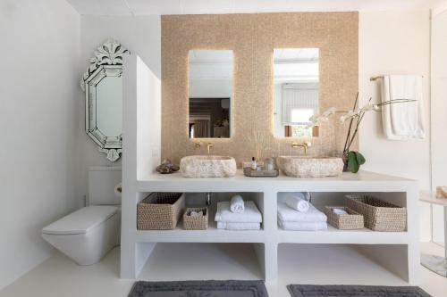 a bathroom with a sink and a mirror at Impressive Ibiza Villa El Zafiro 6 Bedrooms Private Gym & Views in Sant Josep de Sa Talaia