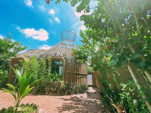 a small house with a straw roof at Tam Coc Sky Bungalow in Ninh Binh
