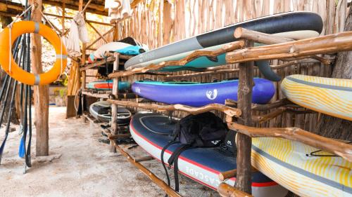 a row of kayaks are lined up on a rack at The Mida Creek Hotel in Watamu