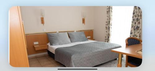 Postel nebo postele na pokoji v ubytování Hotel Victoria