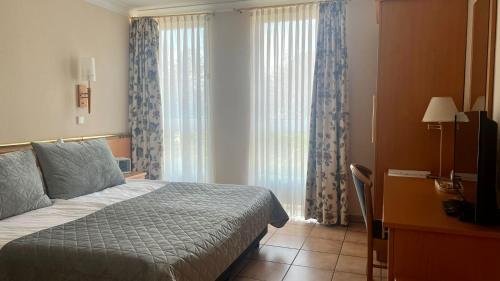 Postel nebo postele na pokoji v ubytování Hotel Victoria